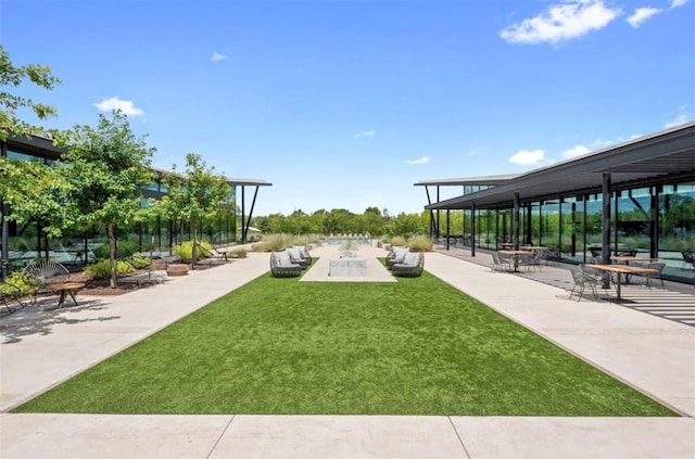 view of community featuring a patio and a yard