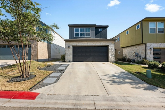 view of front of property featuring a front yard and a garage