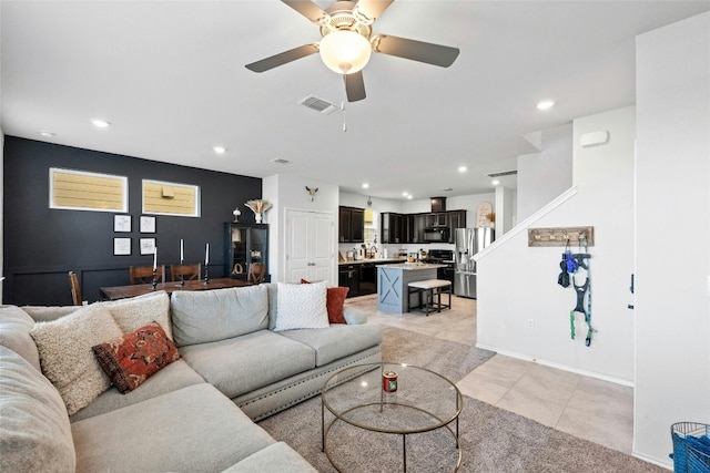 tiled living room featuring ceiling fan