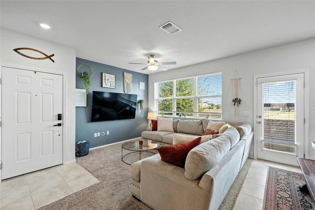 tiled living room with ceiling fan and a wealth of natural light