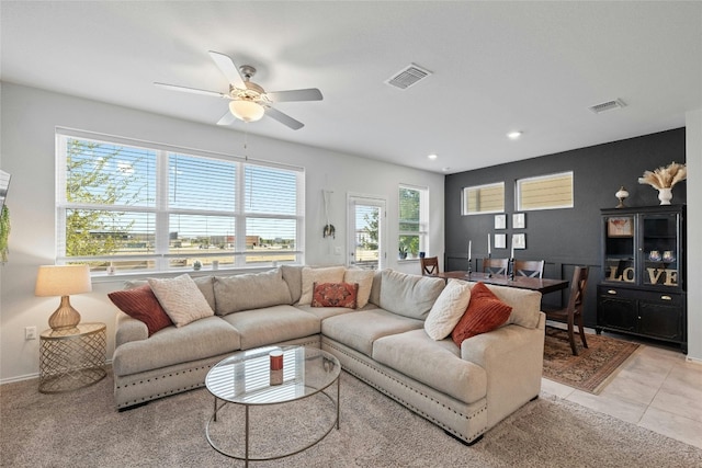 living room featuring light tile patterned flooring and ceiling fan