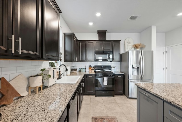 kitchen featuring sink, black appliances, light tile patterned floors, light stone counters, and tasteful backsplash