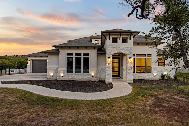 view of front of property featuring a yard and a garage