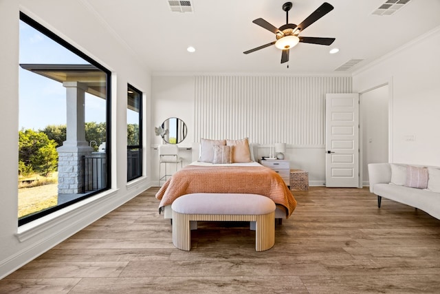 bedroom with multiple windows, light wood-type flooring, and ceiling fan