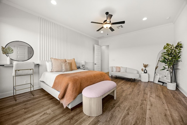 bedroom with ornamental molding, hardwood / wood-style floors, and ceiling fan