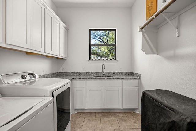 washroom featuring cabinets, sink, separate washer and dryer, and light tile patterned floors