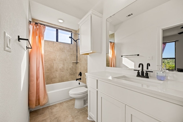 full bathroom featuring a healthy amount of sunlight, vanity, shower / bath combo, and toilet