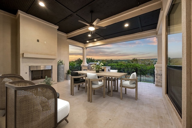 patio terrace at dusk featuring ceiling fan