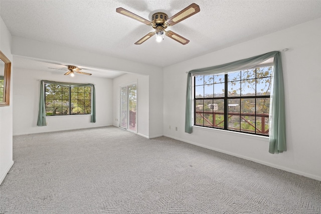 unfurnished room with ceiling fan, carpet, and a textured ceiling