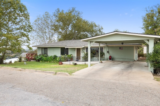 ranch-style house with a front lawn, covered porch, and a carport