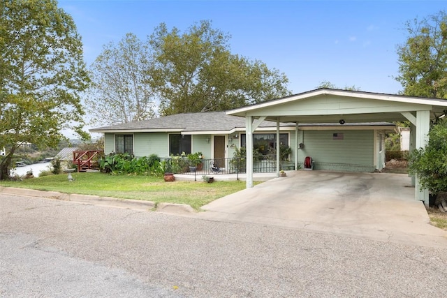 502 E Ave, Marble Falls, TX 78654 - ranch-style house with a front yard, driveway, and a carport