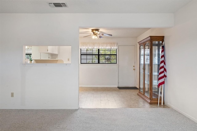 502 E Ave, Marble Falls, TX 78654 - carpeted entryway featuring a ceiling fan and baseboards