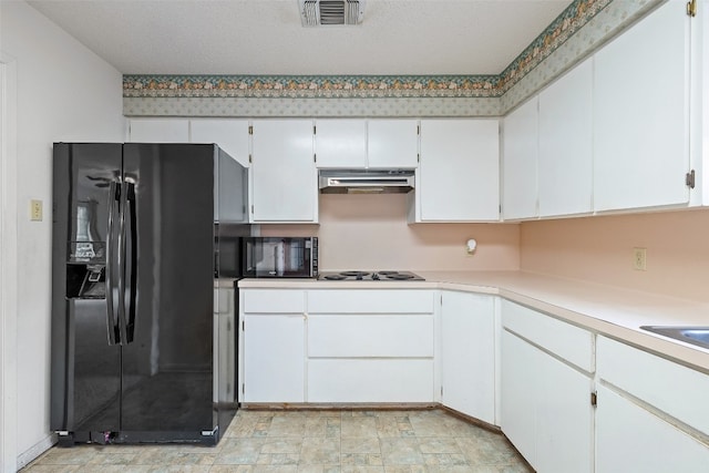 kitchen with white cabinets, black appliances, and a textured ceiling