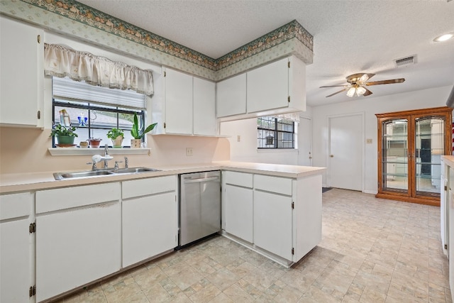 kitchen with a wealth of natural light, stainless steel dishwasher, sink, and white cabinetry