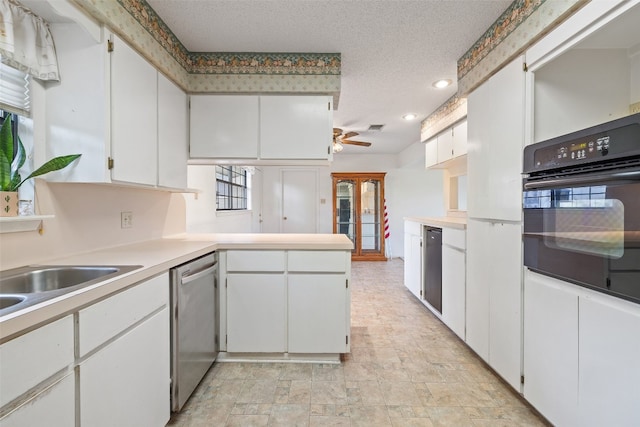 kitchen featuring a wealth of natural light, black oven, stainless steel dishwasher, and white cabinets