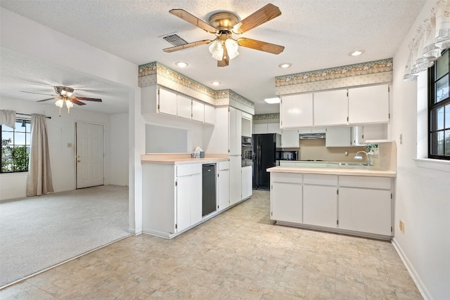 kitchen with a textured ceiling and white cabinets