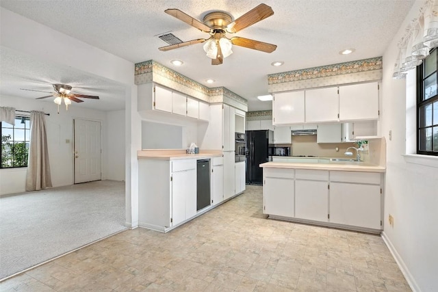 502 E Ave, Marble Falls, TX 78654 - kitchen featuring ceiling fan, a textured ceiling, black appliances, a peninsula, and baseboards