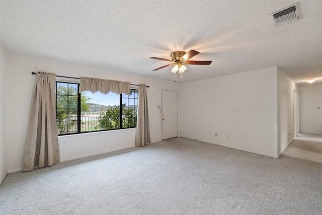 502 E Ave, Marble Falls, TX 78654 - empty room with light carpet, a ceiling fan, a textured ceiling, and baseboards