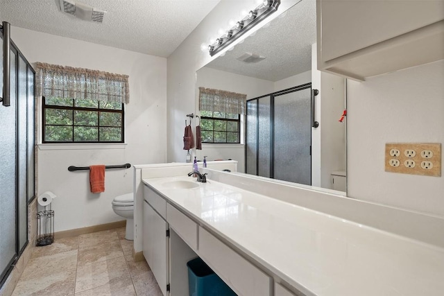 502 E Ave, Marble Falls, TX 78654 - full bathroom with toilet, a shower stall, vanity, a textured ceiling, and baseboards