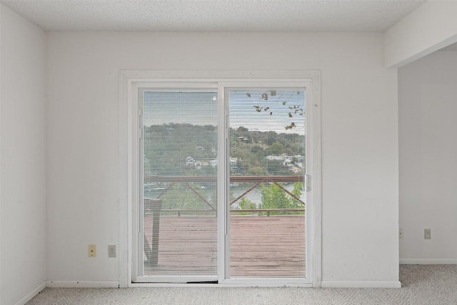 502 E Ave, Marble Falls, TX 78654 - doorway to outside with carpet flooring and baseboards
