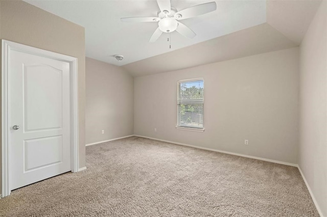 carpeted spare room with lofted ceiling and ceiling fan