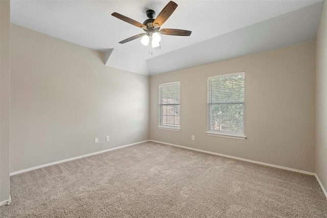 spare room with ceiling fan, carpet flooring, and vaulted ceiling