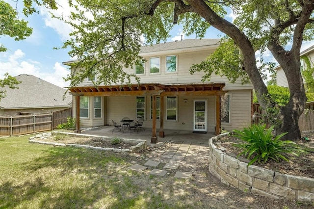 rear view of house featuring a yard, a patio area, and a pergola