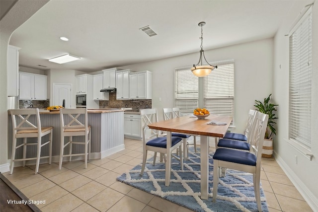 dining area with light tile patterned floors