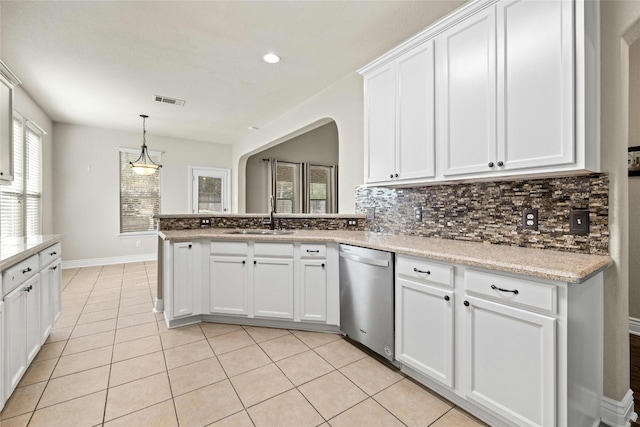 kitchen featuring light tile patterned flooring, sink, backsplash, white cabinetry, and stainless steel dishwasher