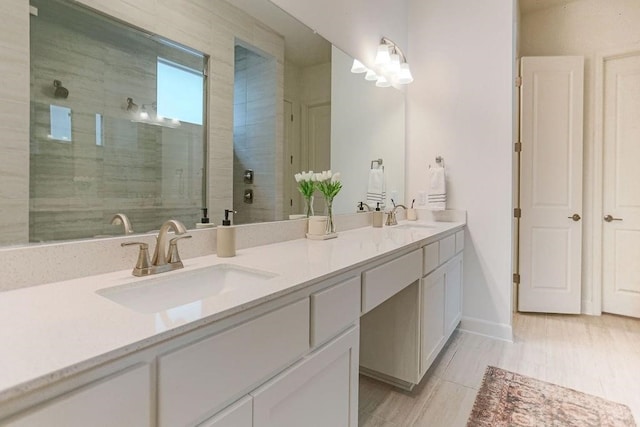 bathroom featuring vanity, wood-type flooring, and an enclosed shower