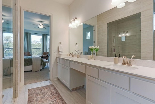 bathroom featuring vanity, ceiling fan, and walk in shower