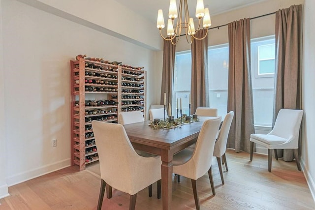 dining area with an inviting chandelier and light wood-type flooring