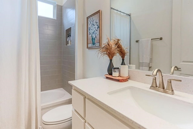 full bathroom featuring vanity, shower / bath combination with curtain, and toilet