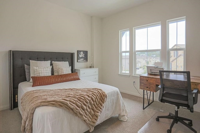 bedroom with multiple windows and light colored carpet