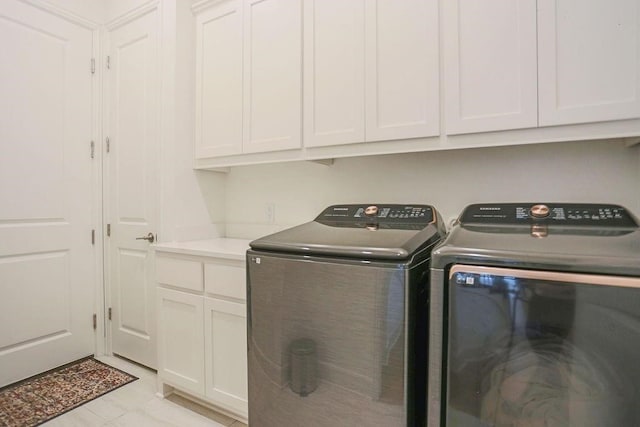 washroom featuring cabinets and separate washer and dryer