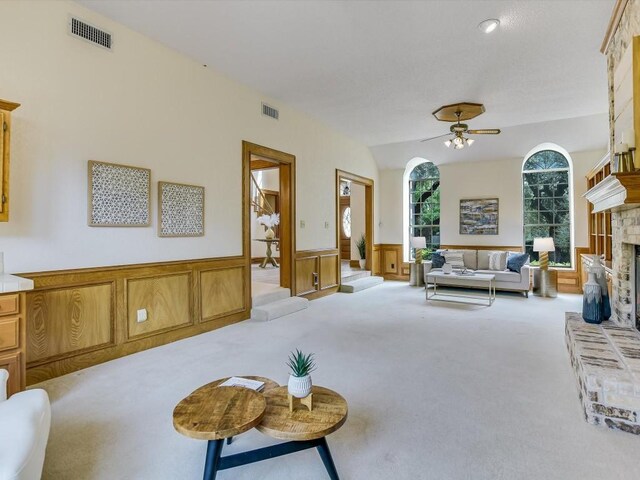 carpeted living room featuring lofted ceiling and ceiling fan