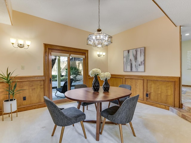 dining space with an inviting chandelier and light colored carpet