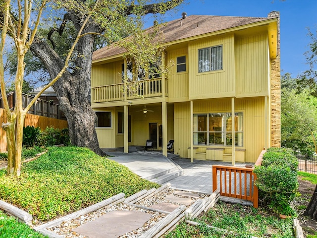 back of property with ceiling fan, a patio, and a balcony