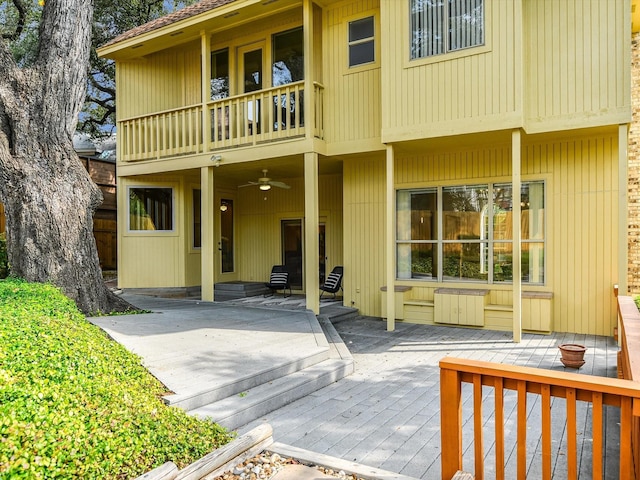 back of property featuring a patio, a balcony, and ceiling fan