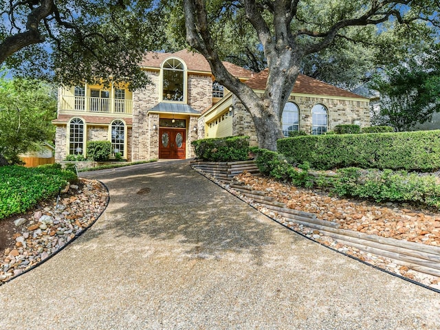 view of front of house featuring a balcony and a garage