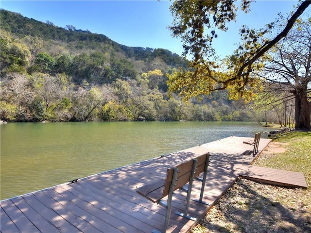 view of dock featuring a water and mountain view