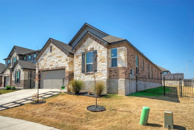 view of front of property with concrete driveway, stone siding, an attached garage, fence, and a front lawn
