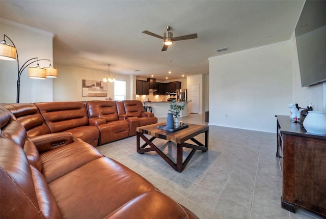 living area with light tile patterned floors, crown molding, visible vents, baseboards, and ceiling fan with notable chandelier