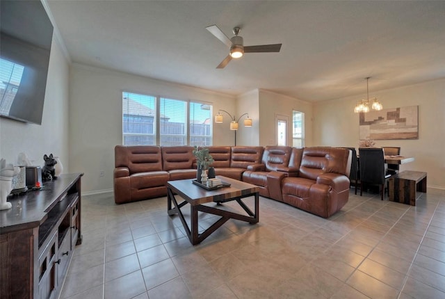 living area with ornamental molding, light tile patterned flooring, baseboards, and ceiling fan with notable chandelier