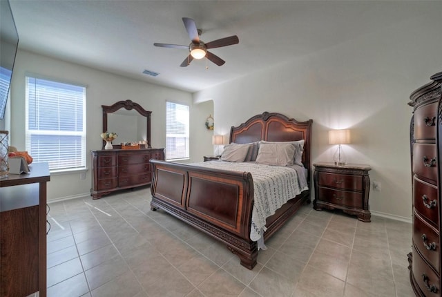bedroom with baseboards, visible vents, light tile patterned floors, and a ceiling fan