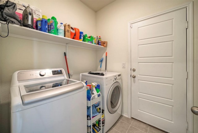 laundry area featuring washer and dryer, light tile patterned flooring, and laundry area