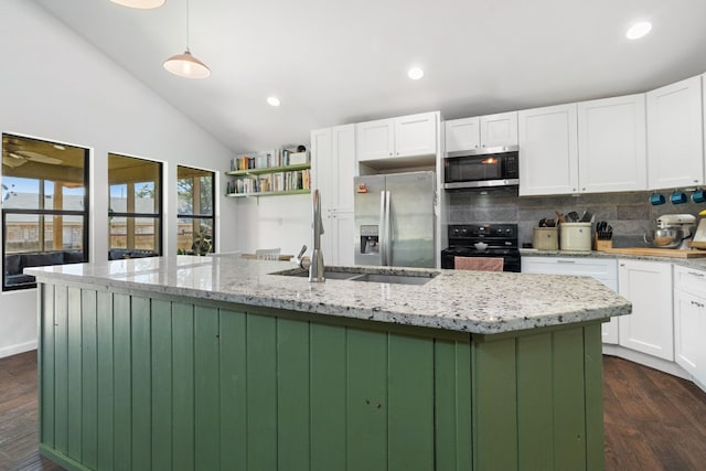 kitchen with dark hardwood / wood-style flooring, stainless steel appliances, a center island with sink, white cabinets, and hanging light fixtures