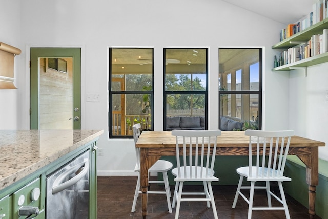 dining space with lofted ceiling, dark wood-type flooring, and beverage cooler