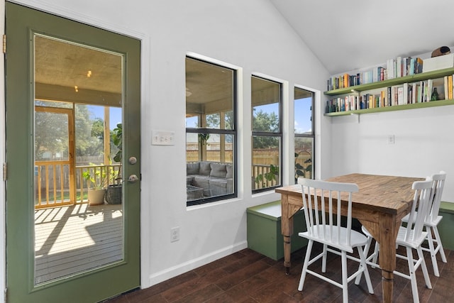 dining area with dark hardwood / wood-style flooring and lofted ceiling