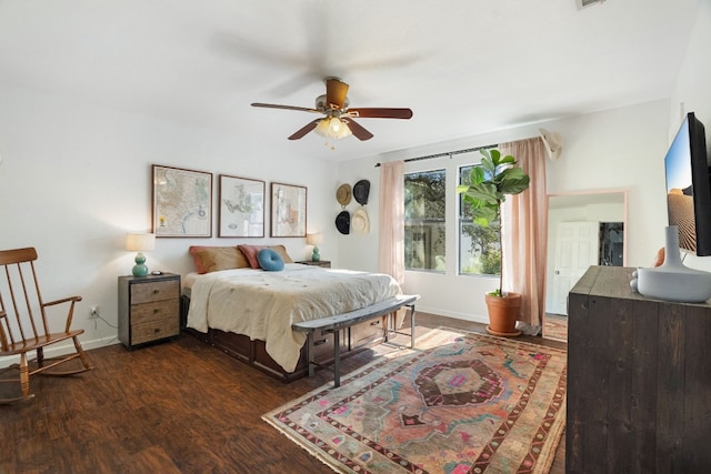 bedroom with ceiling fan and dark hardwood / wood-style flooring